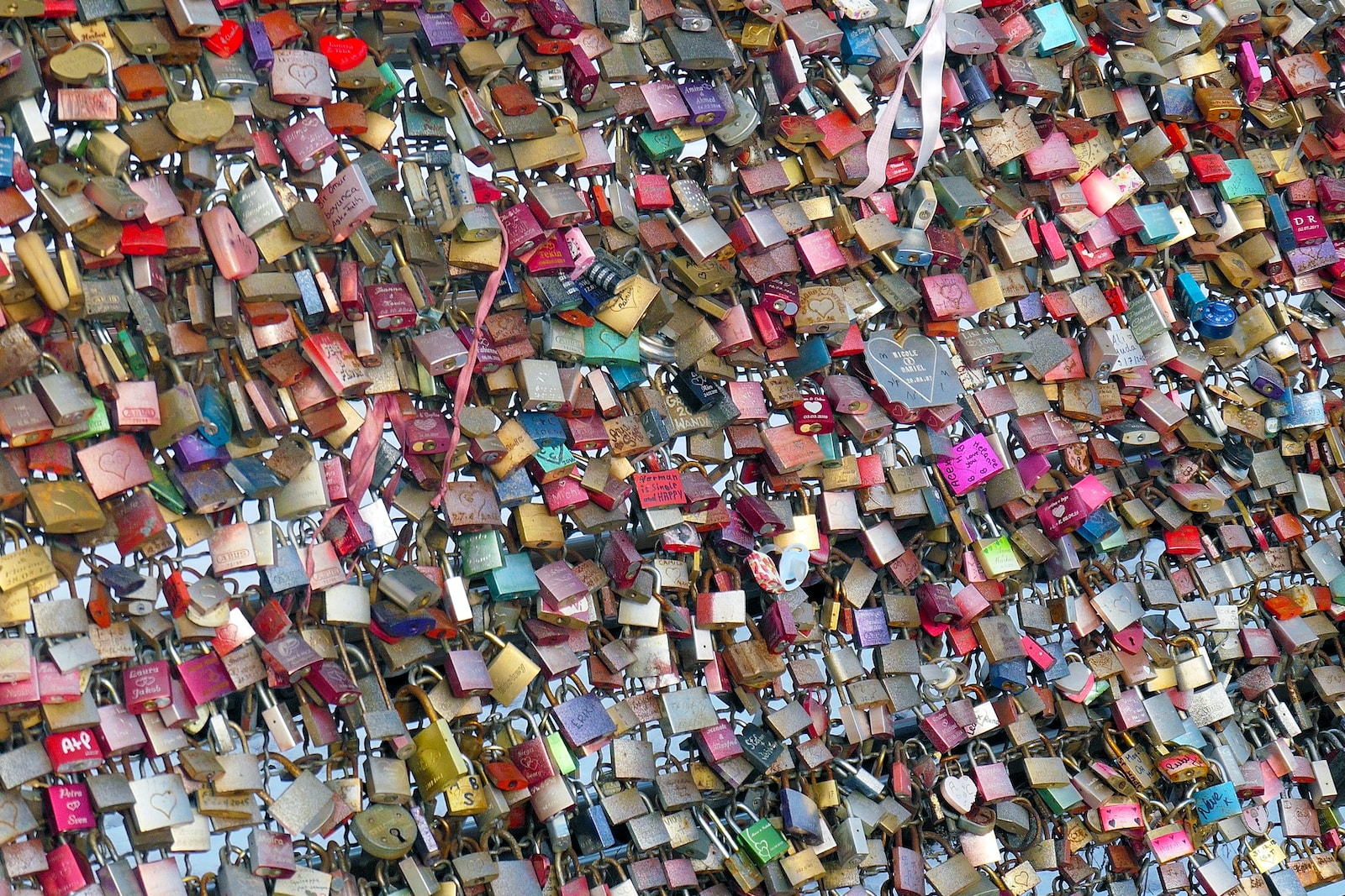 assorted color of padlock on brown wooden fence